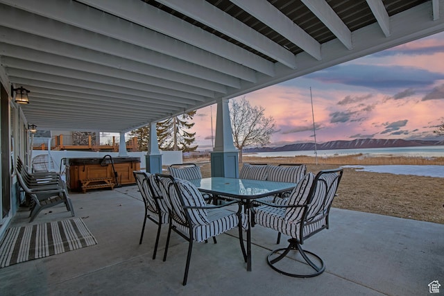 660 S Bear Lake Blvd, Garden City, UT 84028 - view of patio / terrace featuring a hot tub, a water view, and outdoor dining space