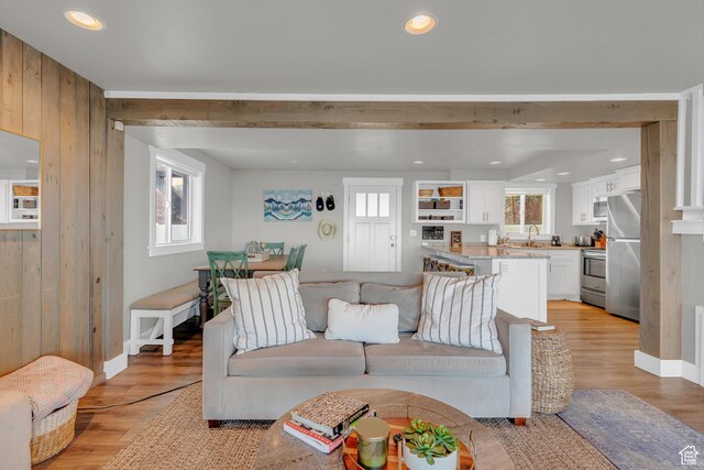 660 S Bear Lake Blvd, Garden City, UT 84028 - living area featuring light wood-style floors, wooden walls, recessed lighting, and baseboards