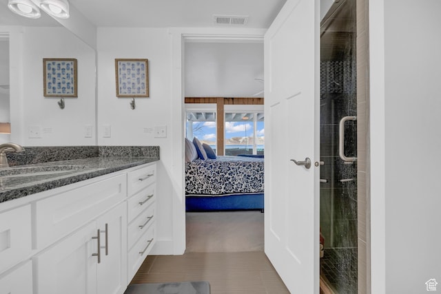 660 S Bear Lake Blvd, Garden City, UT 84028 - ensuite bathroom featuring vanity, a stall shower, and tile patterned flooring