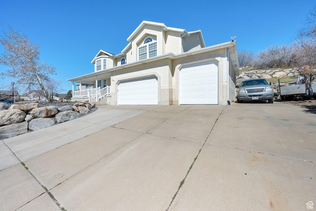 1867 E Indian Ln, Layton, UT 84040 - view of home's exterior with driveway, a porch, and a garage