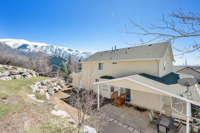 1867 E Indian Ln, Layton, UT 84040 - rear view of property featuring stucco siding, a mountain view, and a patio area