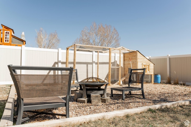 1348 W 200 S, Vernal, UT 84078 - view of yard featuring an outdoor structure, a fenced backyard, exterior structure, and an outdoor fire pit