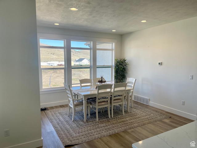 9940 N Vande Way, Eagle Mountain, UT 84005 - dining room featuring wood finished floors, baseboards, and visible vents