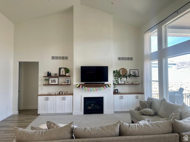 9940 N Vande Way, Eagle Mountain, UT 84005 - living area featuring high vaulted ceiling, visible vents, and a healthy amount of sunlight