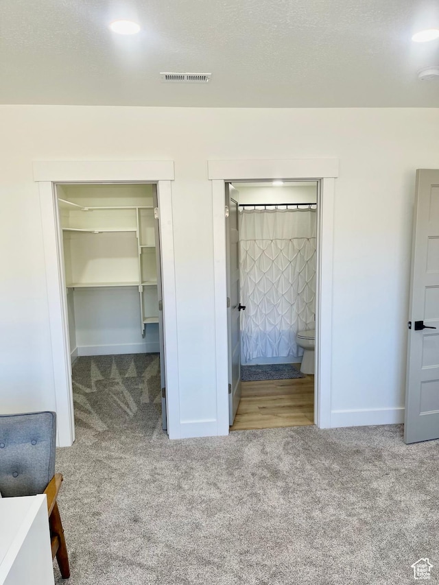 9940 N Vande Way, Eagle Mountain, UT 84005 - unfurnished bedroom with baseboards, a spacious closet, carpet flooring, and ensuite bath