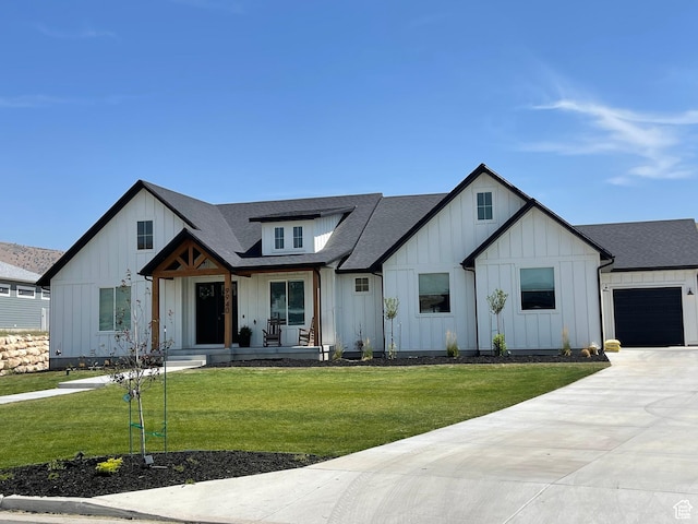 9940 N Vande Way, Eagle Mountain, UT 84005 - modern farmhouse with a front lawn, a shingled roof, covered porch, and board and batten siding