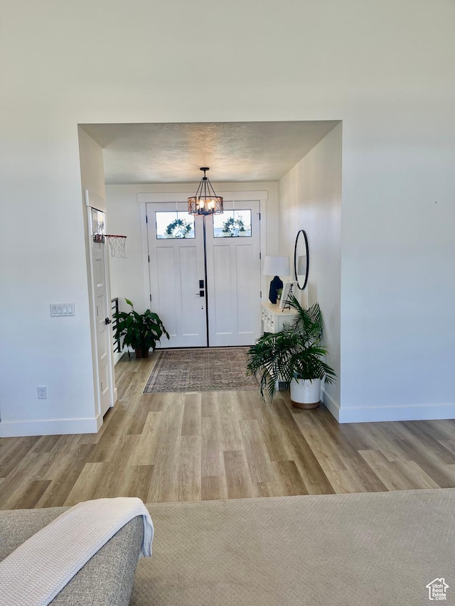 9940 N Vande Way, Eagle Mountain, UT 84005 - foyer entrance featuring baseboards, a chandelier, and wood finished floors