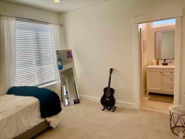 9940 N Vande Way, Eagle Mountain, UT 84005 - bedroom with baseboards, connected bathroom, a sink, and light colored carpet
