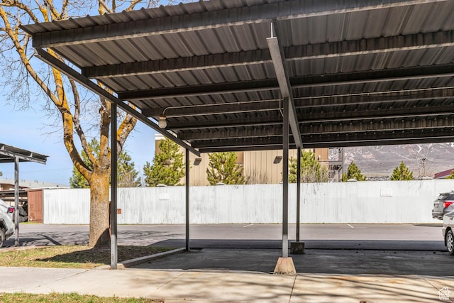 view of parking / parking lot featuring fence