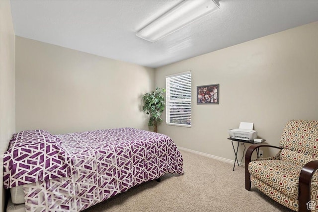 bedroom with baseboards and carpet flooring