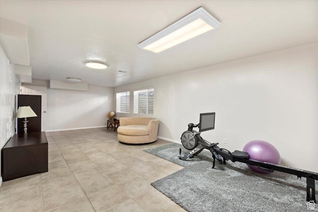workout area with light tile patterned floors and baseboards