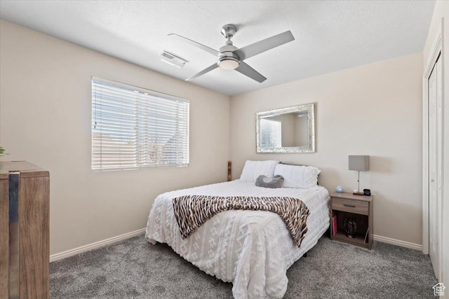 carpeted bedroom featuring a closet, baseboards, ceiling fan, and visible vents