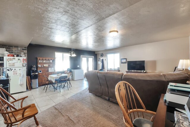 6092 W 13400 S, Herriman, UT 84096 - living area with a textured ceiling, light tile patterned floors, and plenty of natural light