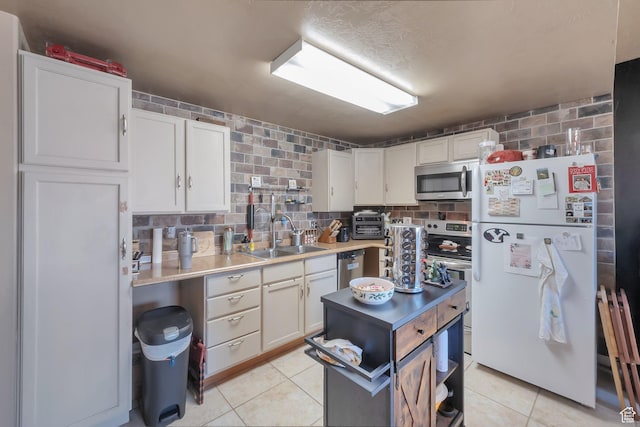 6092 W 13400 S, Herriman, UT 84096 - kitchen featuring a sink, light countertops, white cabinetry, stainless steel appliances, and light tile patterned flooring