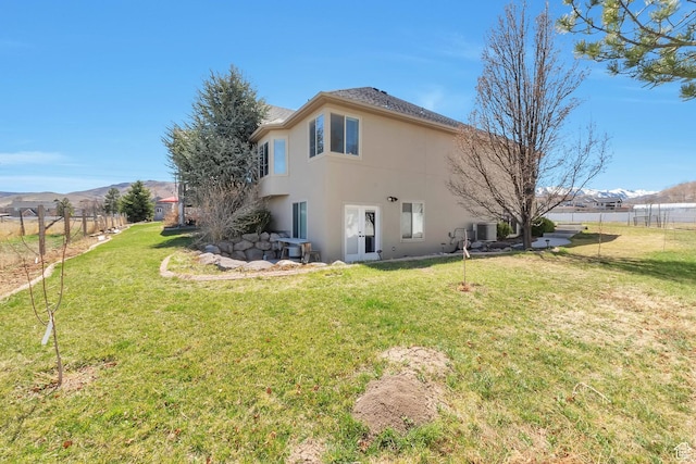 6092 W 13400 S, Herriman, UT 84096 - back of house with a mountain view, fence, a lawn, and stucco siding