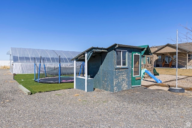 841 N Hale St Unit 1, Grantsville, UT 84029 - view of outdoor structure with a trampoline, fence, and a playground