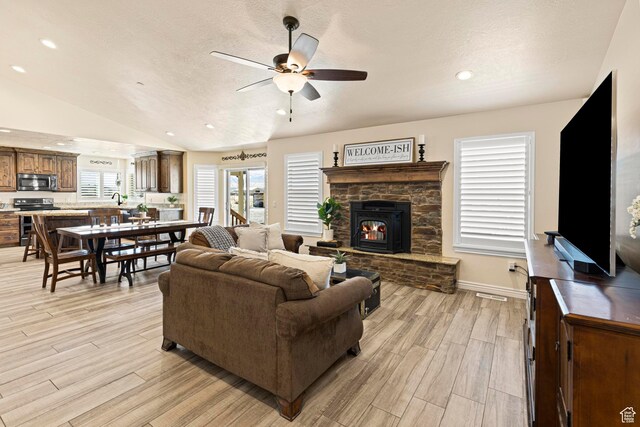 841 N Hale St Unit 1, Grantsville, UT 84029 - living area with ceiling fan, light wood-style flooring, a stone fireplace, recessed lighting, and lofted ceiling