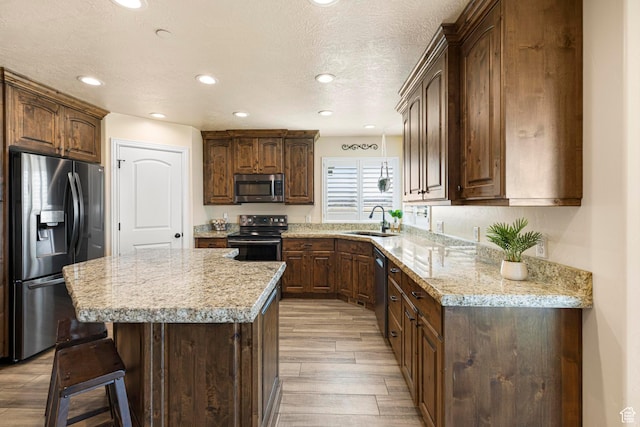 841 N Hale St Unit 1, Grantsville, UT 84029 - kitchen with recessed lighting, a kitchen island, light wood-style floors, appliances with stainless steel finishes, and a sink