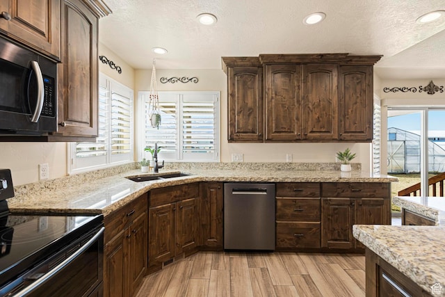 841 N Hale St Unit 1, Grantsville, UT 84029 - kitchen with stainless steel appliances, dark brown cabinetry, a textured ceiling, and a sink