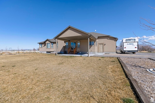 841 N Hale St Unit 1, Grantsville, UT 84029 - back of property featuring a yard, entry steps, fence, and stucco siding