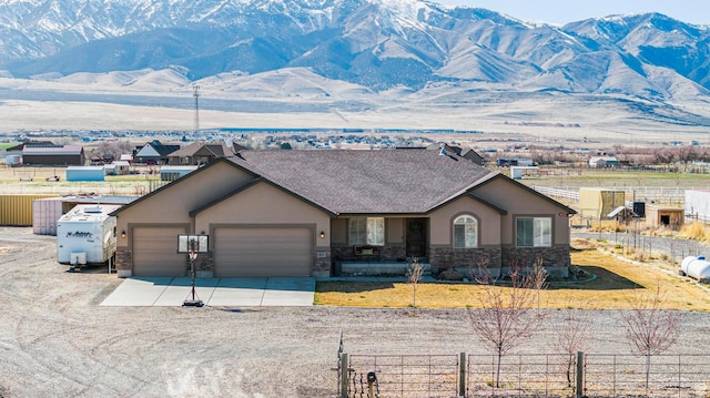 841 N Hale St Unit 1, Grantsville, UT 84029 - view of front of property featuring a mountain view, an attached garage, fence, and stucco siding