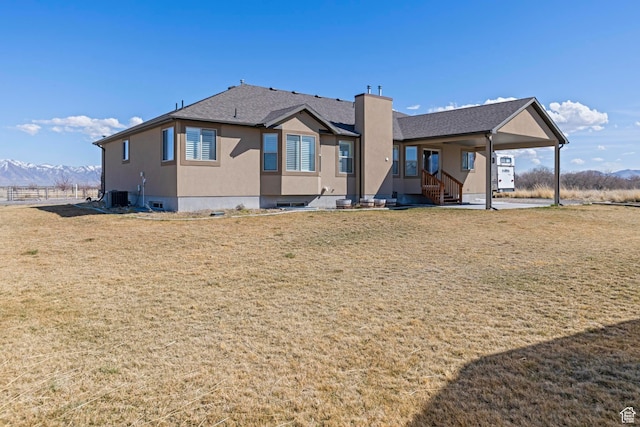 841 N Hale St Unit 1, Grantsville, UT 84029 - back of house with central AC, a yard, stucco siding, a mountain view, and an attached carport