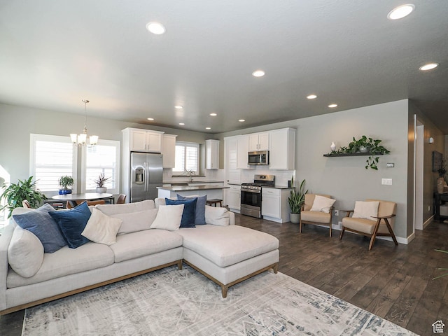 3631 W Cornstalk Way S, Riverton, UT 84065 - living room featuring an inviting chandelier, dark wood-style flooring, baseboards, and recessed lighting