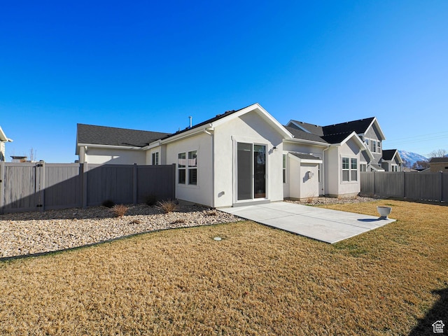 3631 W Cornstalk Way S, Riverton, UT 84065 - rear view of house featuring a fenced backyard, stucco siding, a yard, and a patio
