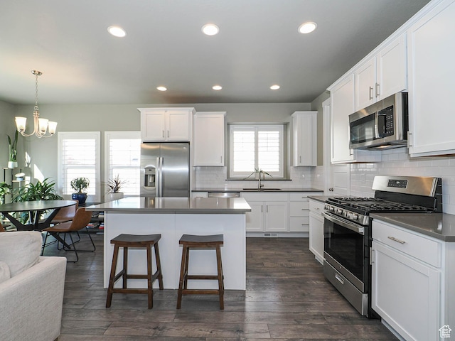 3631 W Cornstalk Way S, Riverton, UT 84065 - kitchen featuring white cabinets, stainless steel appliances, dark wood-style floors, and a notable chandelier