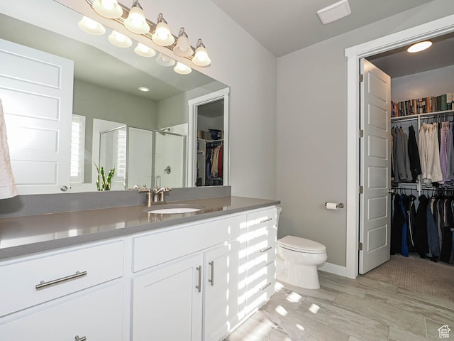 3631 W Cornstalk Way S, Riverton, UT 84065 - bathroom featuring toilet, vanity, a shower stall, a walk in closet, and baseboards
