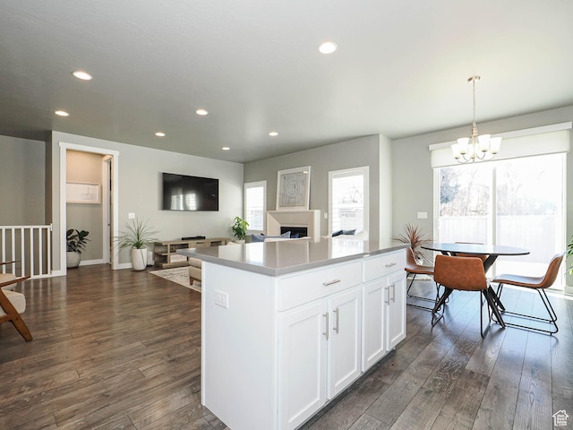 3631 W Cornstalk Way S, Riverton, UT 84065 - kitchen with recessed lighting, dark wood-type flooring, a chandelier, a kitchen island, and white cabinets