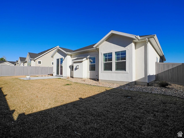 3631 W Cornstalk Way S, Riverton, UT 84065 - back of property featuring stucco siding, a fenced backyard, a yard, and a patio area