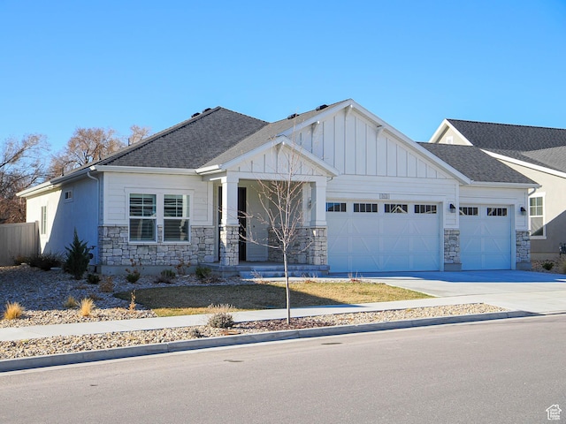 3631 W Cornstalk Way S, Riverton, UT 84065 - view of front of home with stone siding, an attached garage, concrete driveway, and board and batten siding
