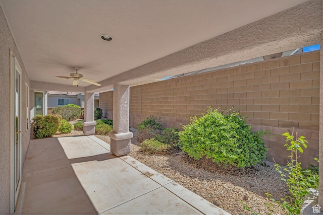 view of patio featuring a ceiling fan and fence