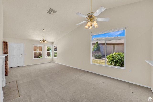 carpeted spare room featuring a chandelier, vaulted ceiling, baseboards, and ceiling fan