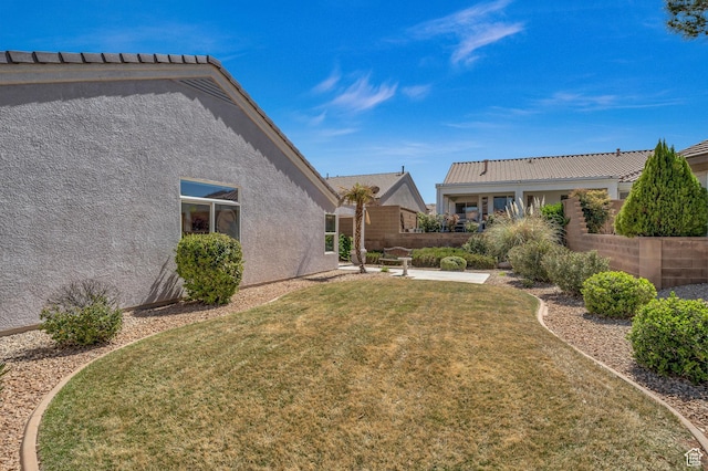 view of grassy yard with a patio