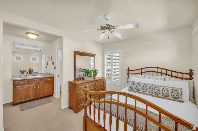 bedroom with a wall mounted AC, a sink, light colored carpet, and baseboards