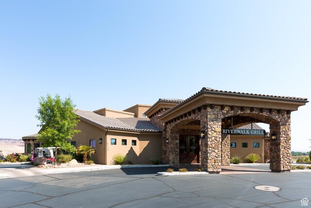 1673 W Warm River Dr, St George, UT 84790 - mediterranean / spanish-style house featuring stone siding, stucco siding, and a tiled roof