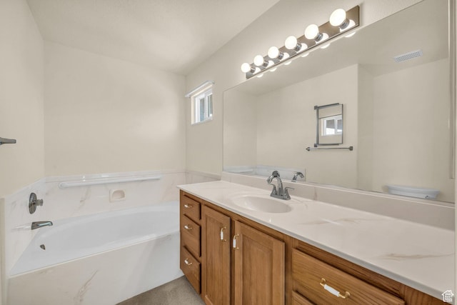 full bathroom with vanity, a garden tub, and toilet