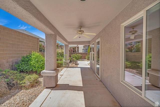 view of patio with a ceiling fan and fence