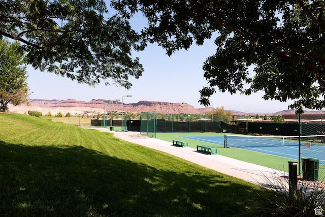 view of tennis court featuring a mountain view