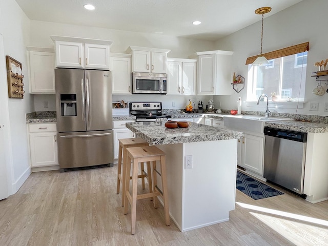 446 E Rue De Paris, Vineyard, UT 84059 - kitchen featuring white cabinets, stainless steel appliances, and light wood-style flooring