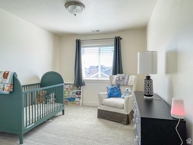 446 E Rue De Paris, Vineyard, UT 84059 - bedroom with a textured ceiling, visible vents, a nursery area, baseboards, and carpet floors