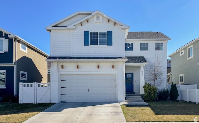 traditional home featuring concrete driveway, a front yard, an attached garage, and fence