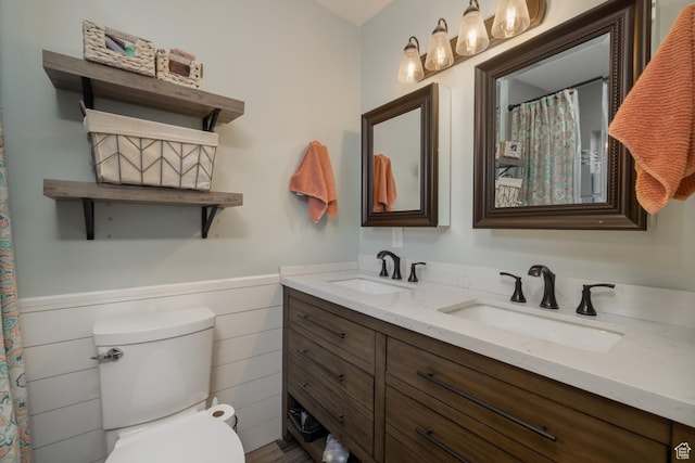 380 S 100 E, Vernal, UT 84078 - bathroom featuring double vanity, wainscoting, toilet, and a sink