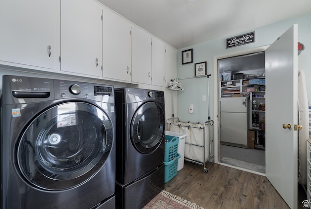380 S 100 E, Vernal, UT 84078 - washroom featuring washing machine and clothes dryer, cabinet space, and dark wood-type flooring