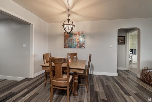 380 S 100 E, Vernal, UT 84078 - dining space with arched walkways, dark wood-style flooring, baseboards, and an inviting chandelier