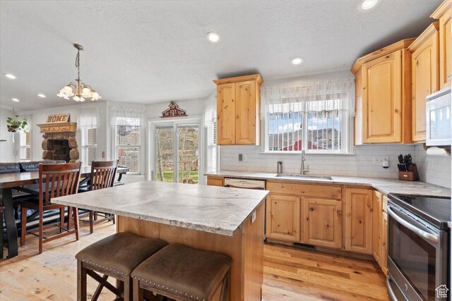 7217 W Mccuiston Ave S, Herriman, UT 84096 - kitchen featuring light wood-style flooring, a sink, light brown cabinetry, and white appliances