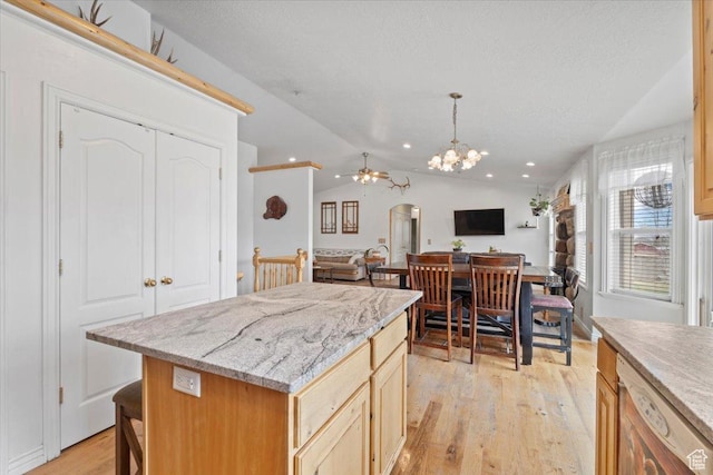 7217 W Mccuiston Ave S, Herriman, UT 84096 - kitchen with a chandelier, light wood finished floors, open floor plan, dishwashing machine, and lofted ceiling