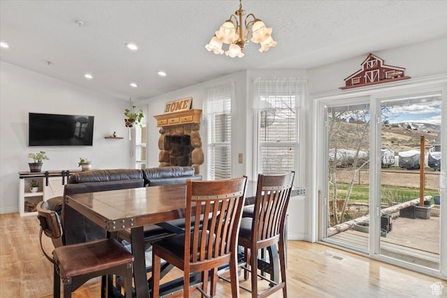 7217 W Mccuiston Ave S, Herriman, UT 84096 - dining room featuring a textured ceiling, light wood-type flooring, lofted ceiling, recessed lighting, and an inviting chandelier